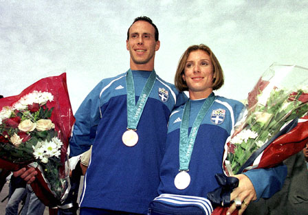 Greek Olympic medalists Costas Kenteris (L) and Katerina Thanou (R) pose to photographers upon their arrival from Sydney 2000 Olympic Games in this file photograph taken October 3, 2000. The disgraced sprinters have been charged with missing a drugs test on the eve of August's Athens 2004 Olympics and faking a mystery motorcycle accident. Prosecutors also charged their former coach Christos Tzekos with obstructing tests and owning, storing and trading banned substances found at his nutrition supplements company. REUTERS/Action Images **GREECE OUT** **NO ARK**